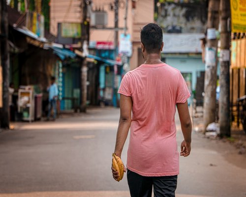 A person walking down a typical urban street with comfortable posture